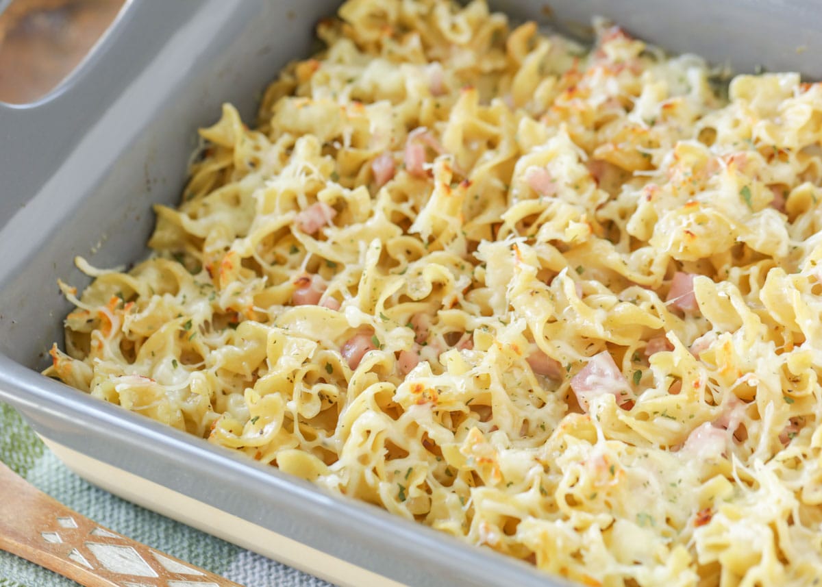 Mac and cheese with ham in a baking dish.