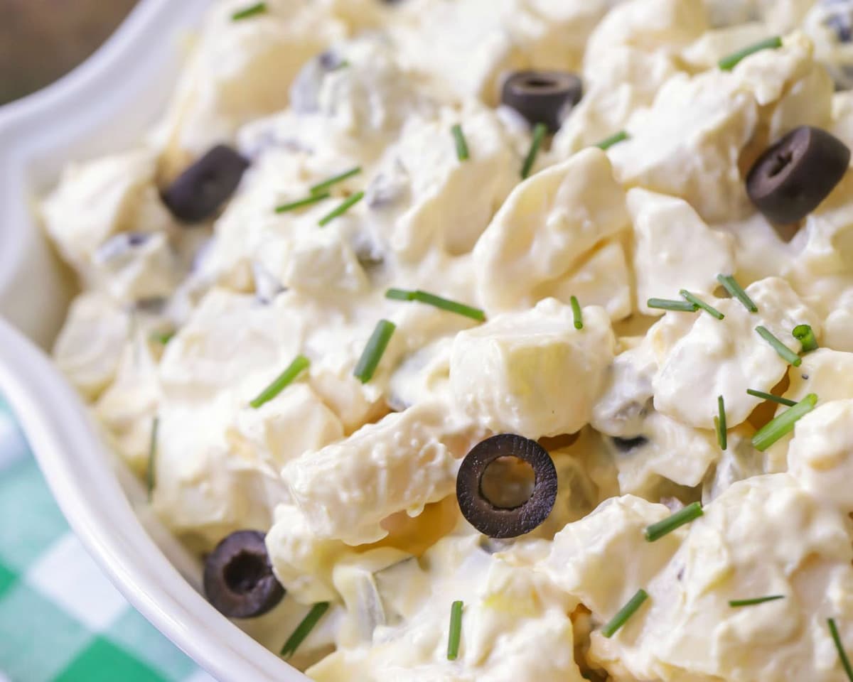 BBQ Side Dishes - Potato Salad with black olives in a white bowl.