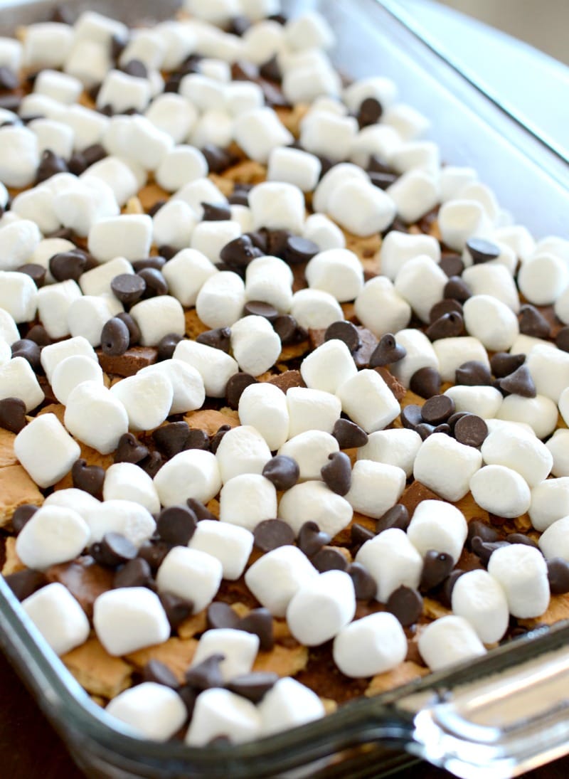 Toppings sprinkled and layered in a glass baking dish