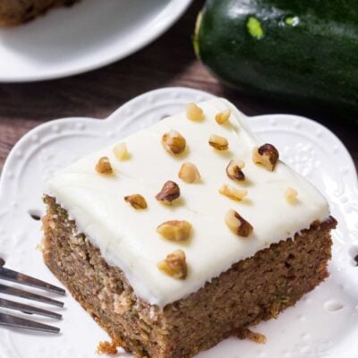 This zucchini cake with cream cheese frosting is moist, filled with spices and the perfect way use up zucchini. Topped with fluffy cream cheese frosting.