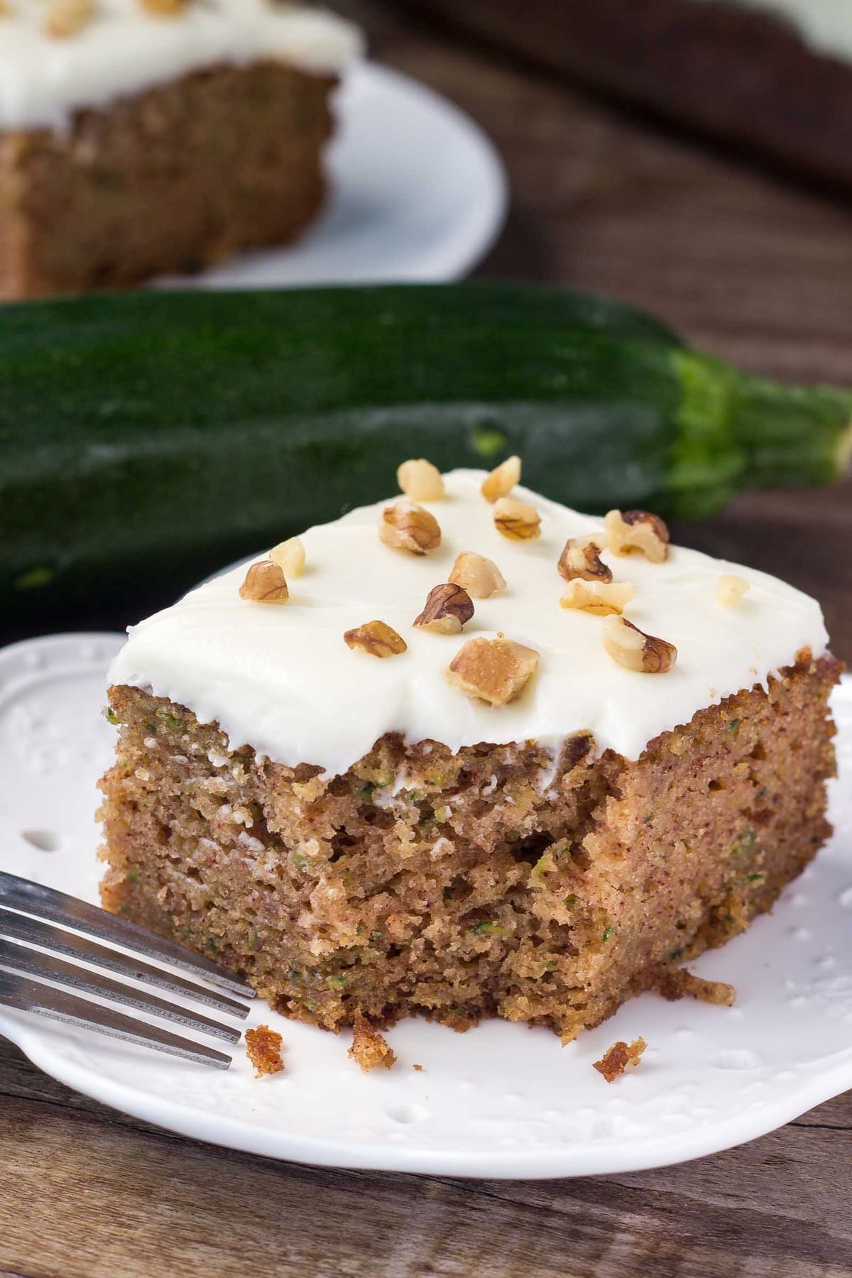 Close up of zucchini cake with a missing bite