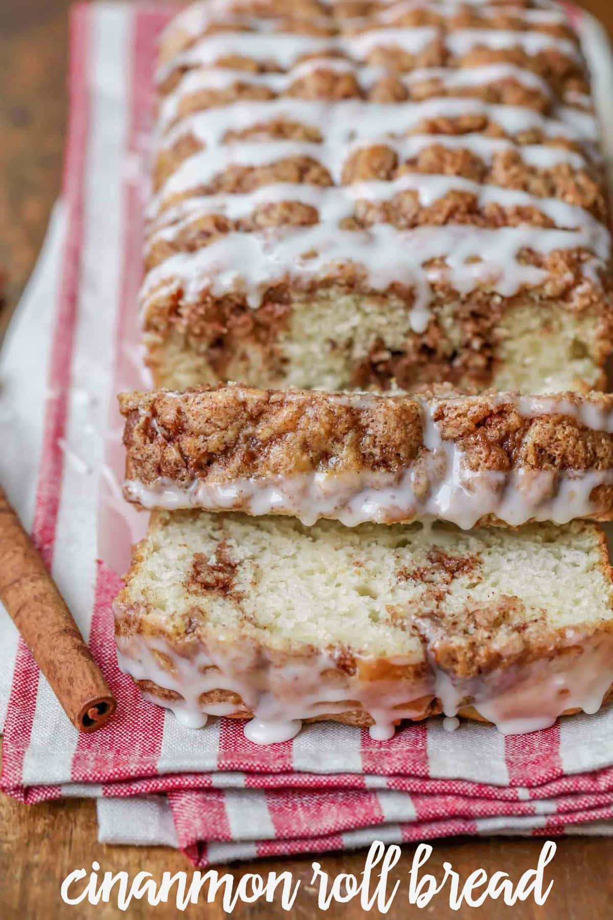 Delicious Cinnamon Swirl Bread sliced and glazed on a tea towel