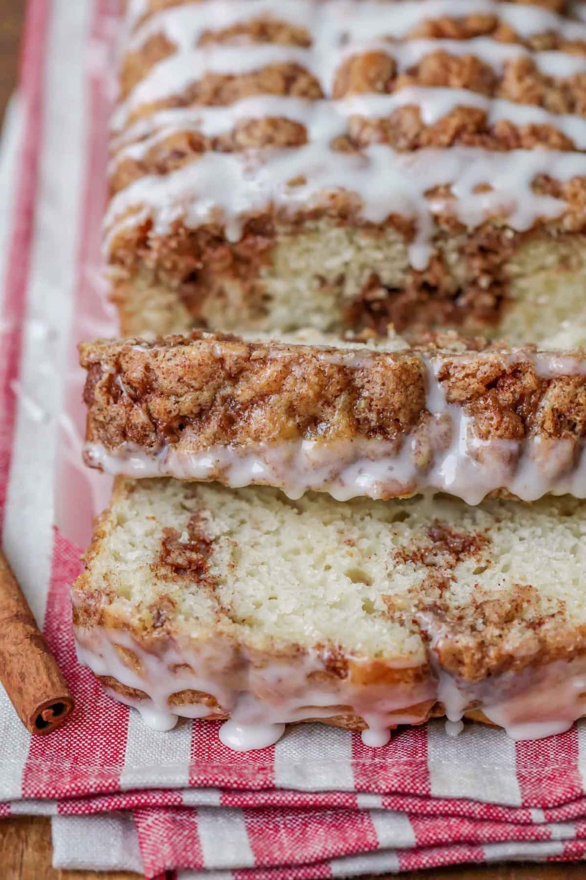 Delicious Cinnamon Swirl Bread sliced and glazed on a tea towel