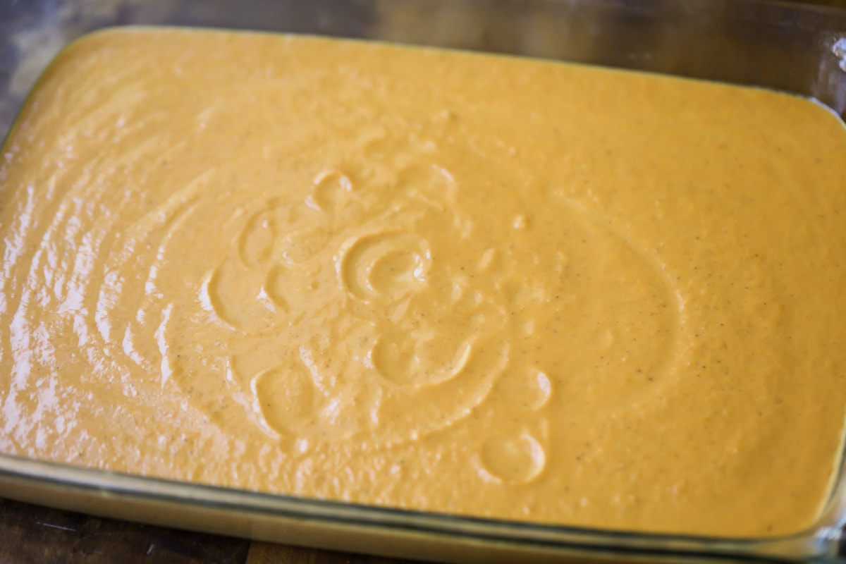 Pumpkin mixture poured into a glass baking dish.