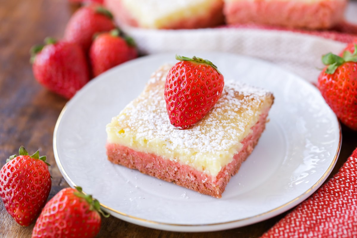 Easy Cake Recipes - Gooey strawberry cake on a white plate.