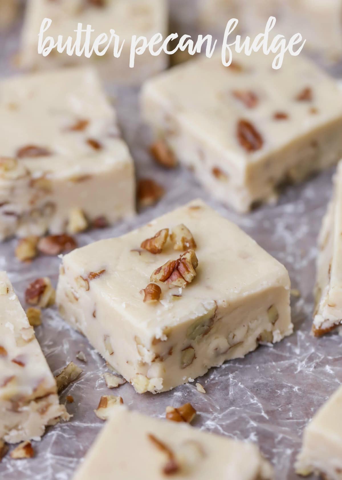 Butter pecan fudge sliced on a sheet of parchment paper