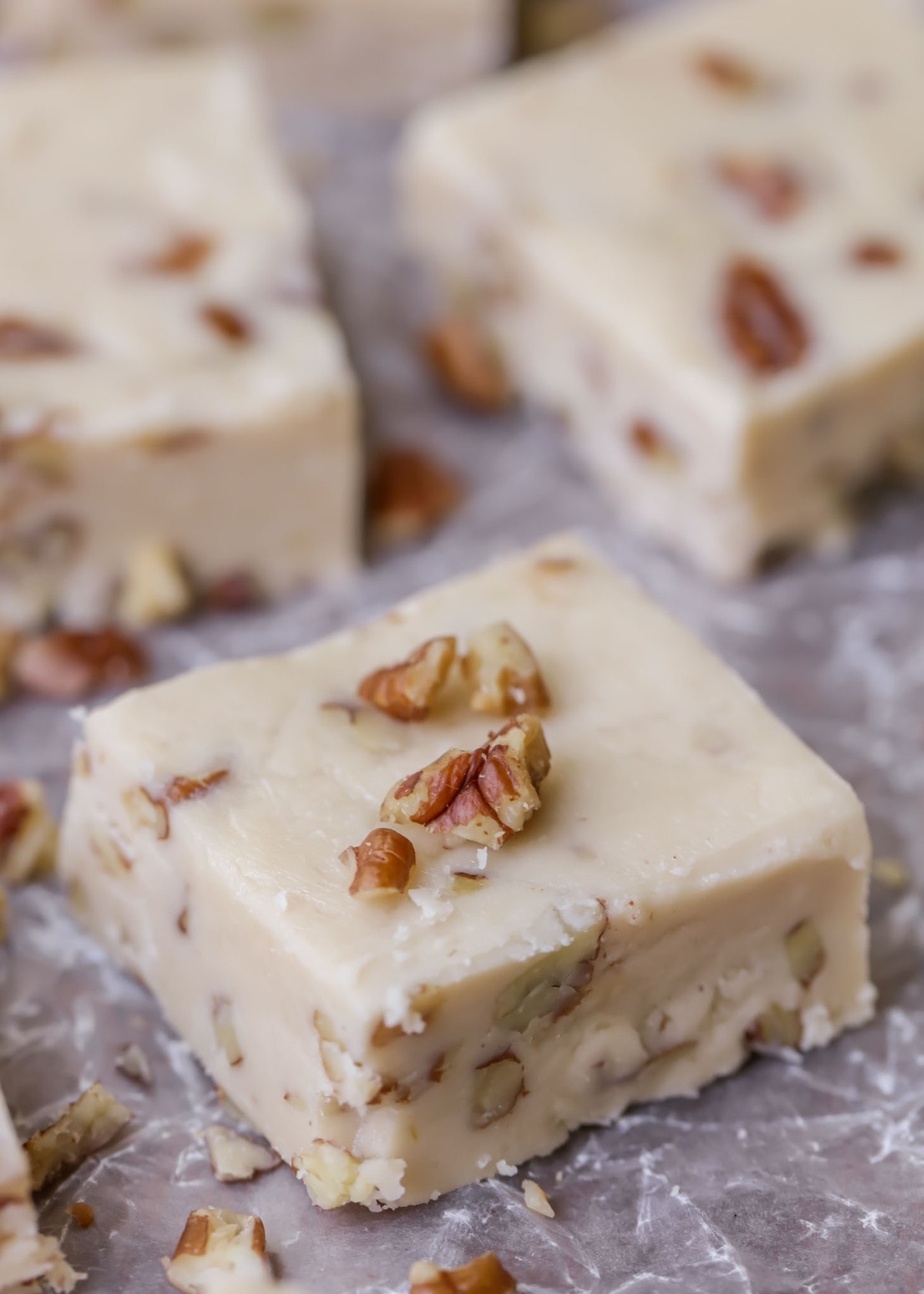 butter pecan fudge sliced on a sheet of parchment paper