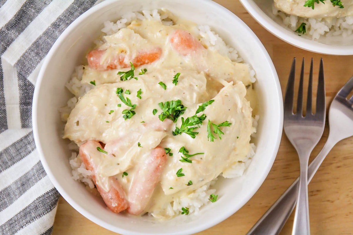 Crockpot Ranch Chicken over rice in a white bowl