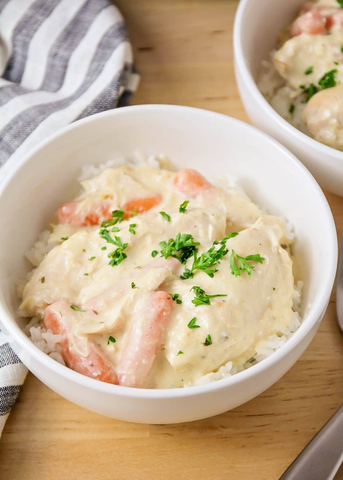 Slow cooker ranch chicken over rice in a white bowl