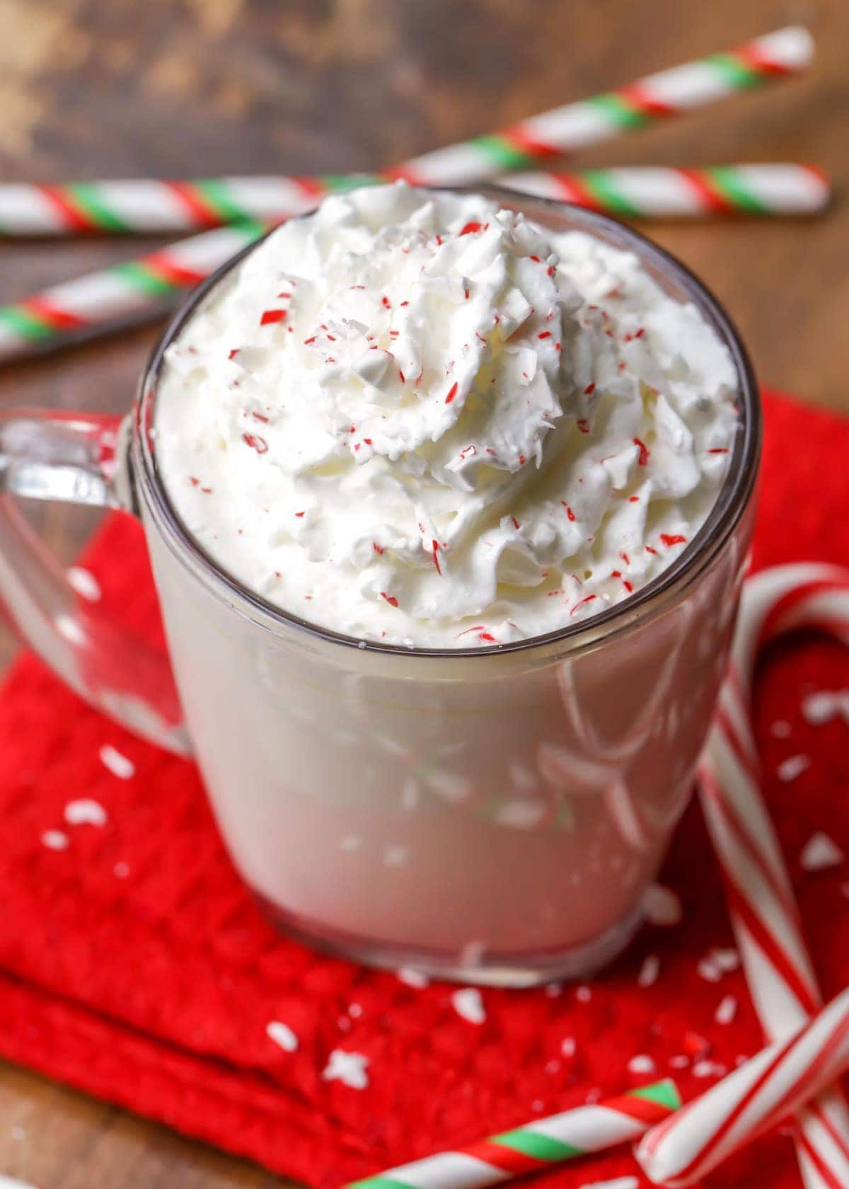 Holiday drink ideas - white chocolate peppermint hot cocoa topped with whipped cream.