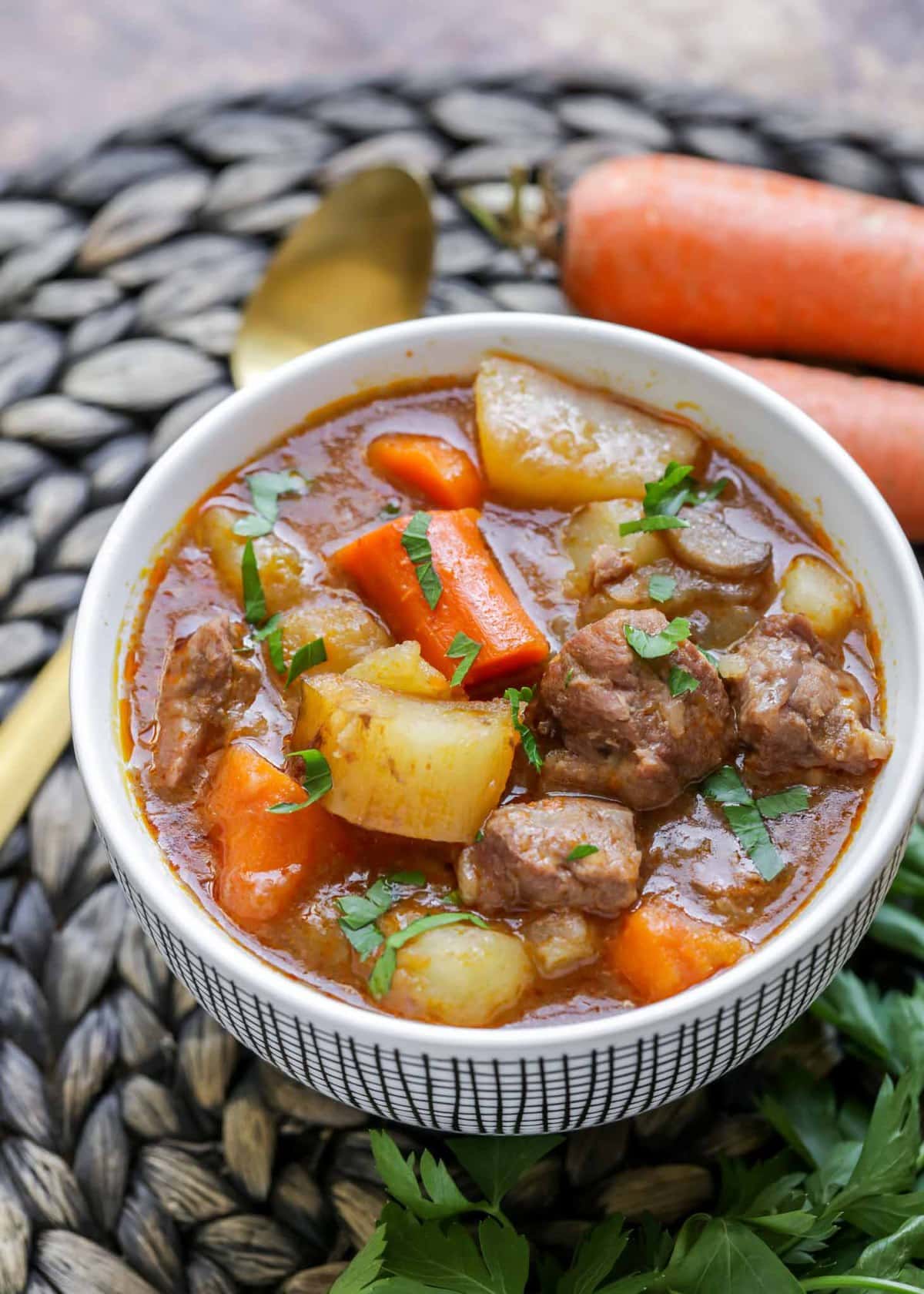 Slow cooker beef stew served in a white bowl.