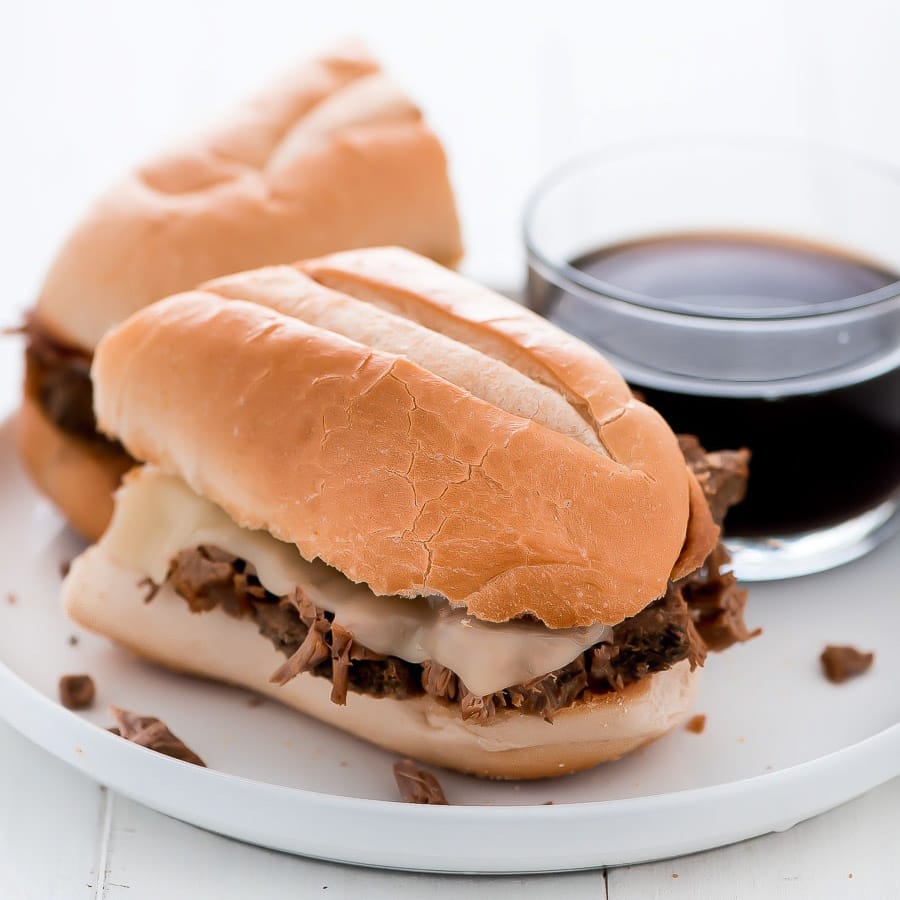 French dip sandwich cut in half and served with au jus