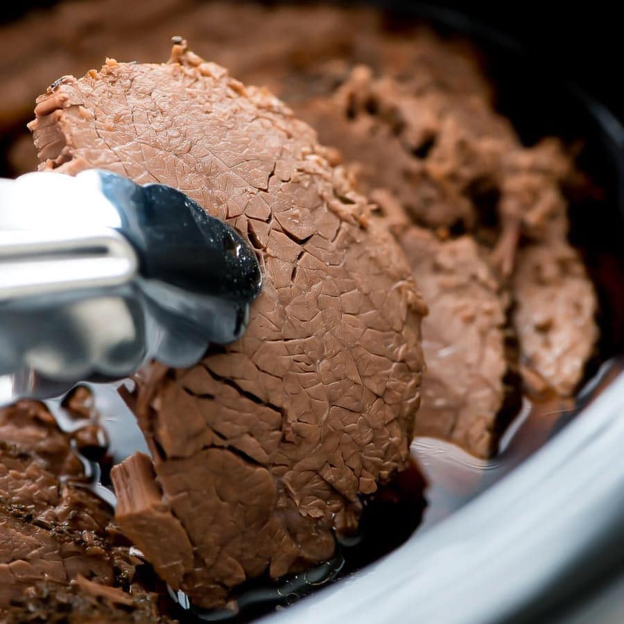 Roast beef slices in the crock pot for french dips