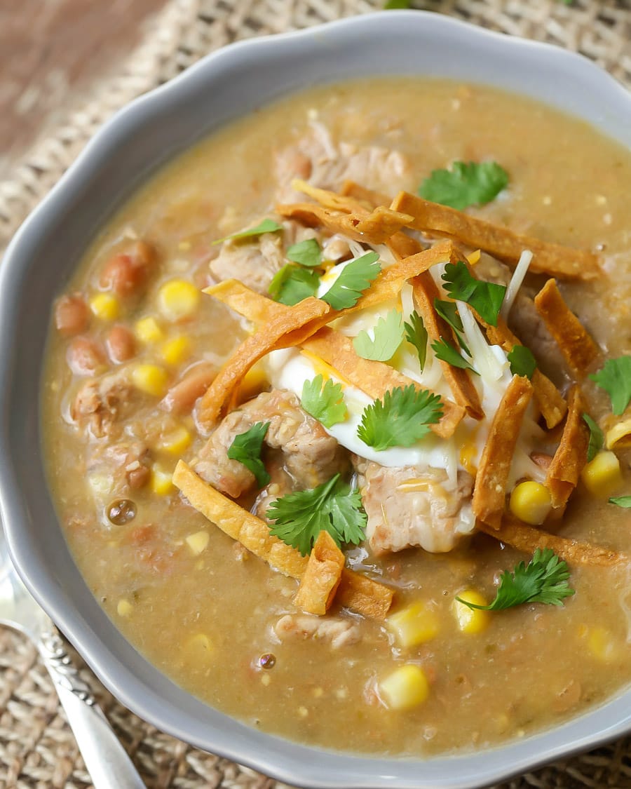 Green Enchilada Pork Chili garnished with tortilla strips and cilantro