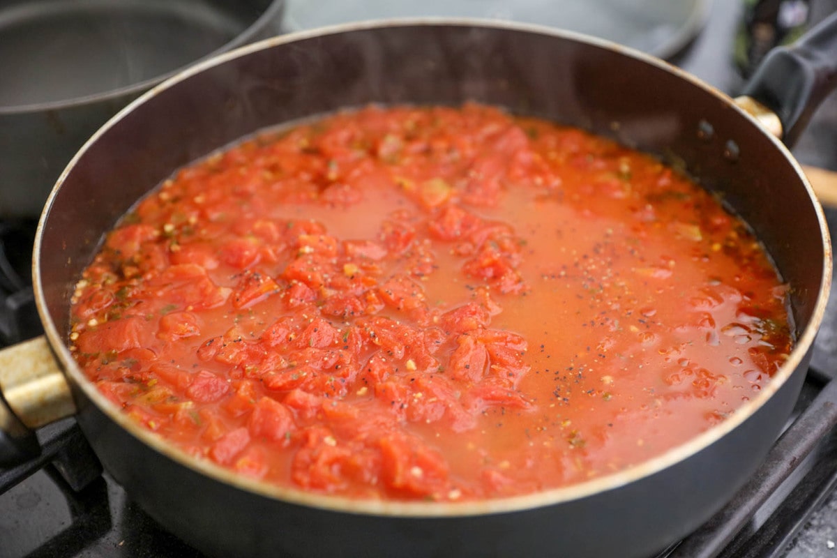 Tomato basil soup ingredients cooking in a pan