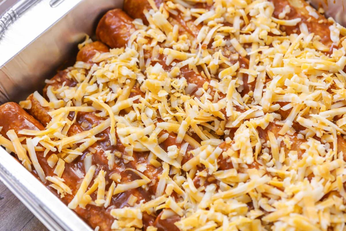 Red Enchiladas with cheese on top in baking dish