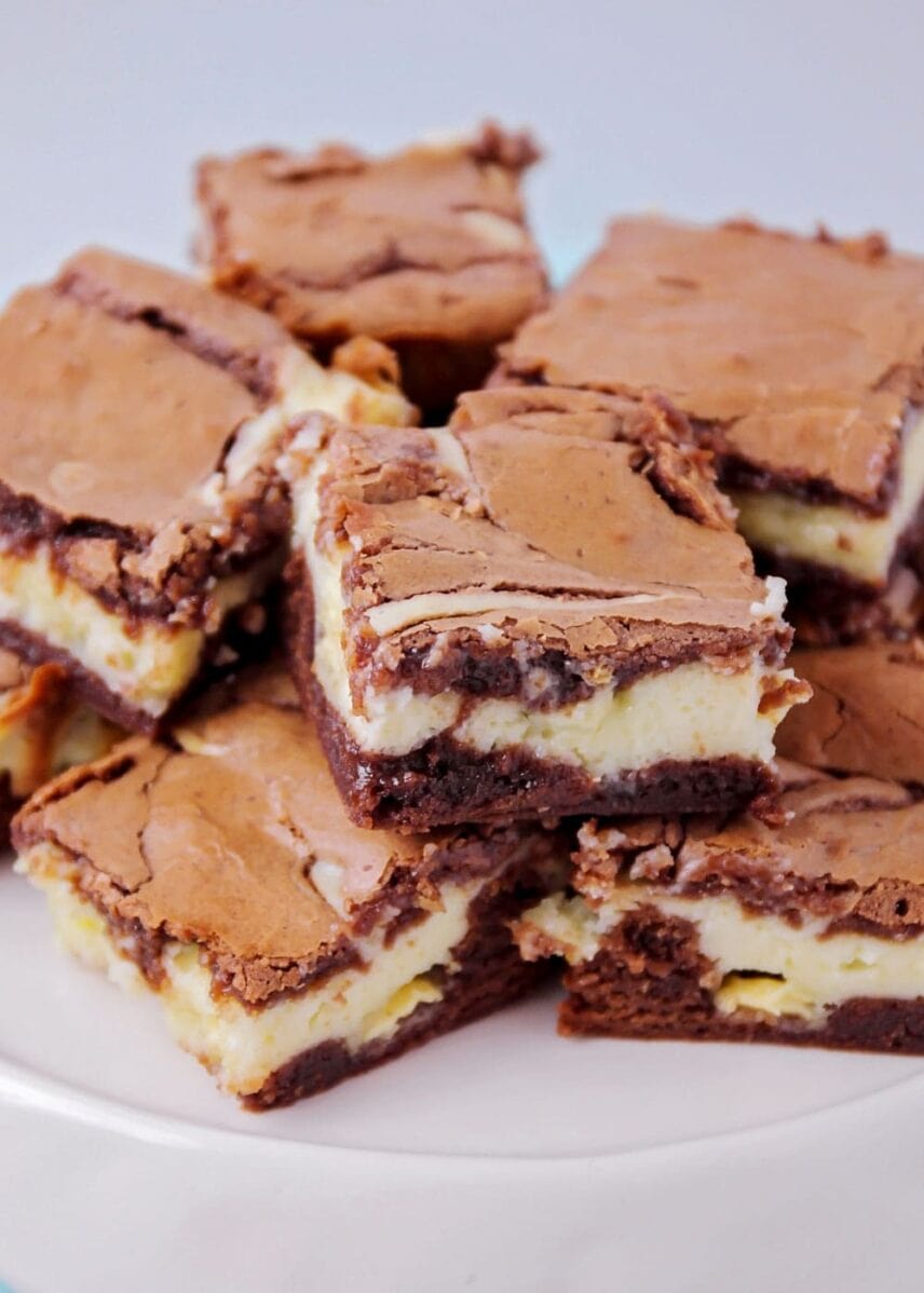 Cheesecake brownies stacked on top of each other.