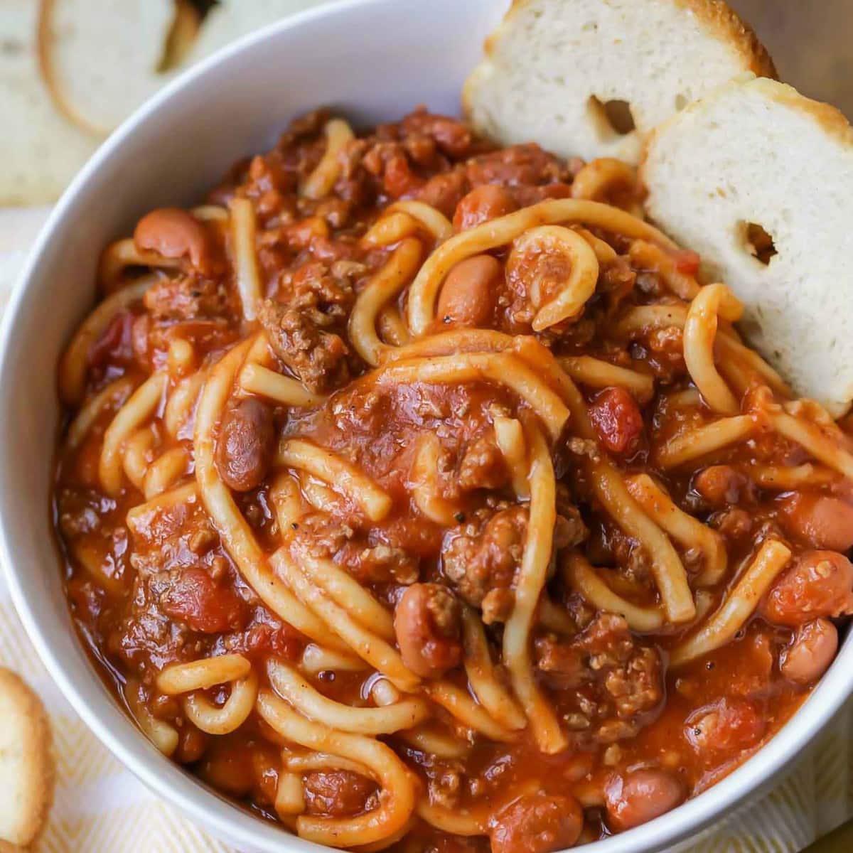 Chili Spaghetti served with bread slices.