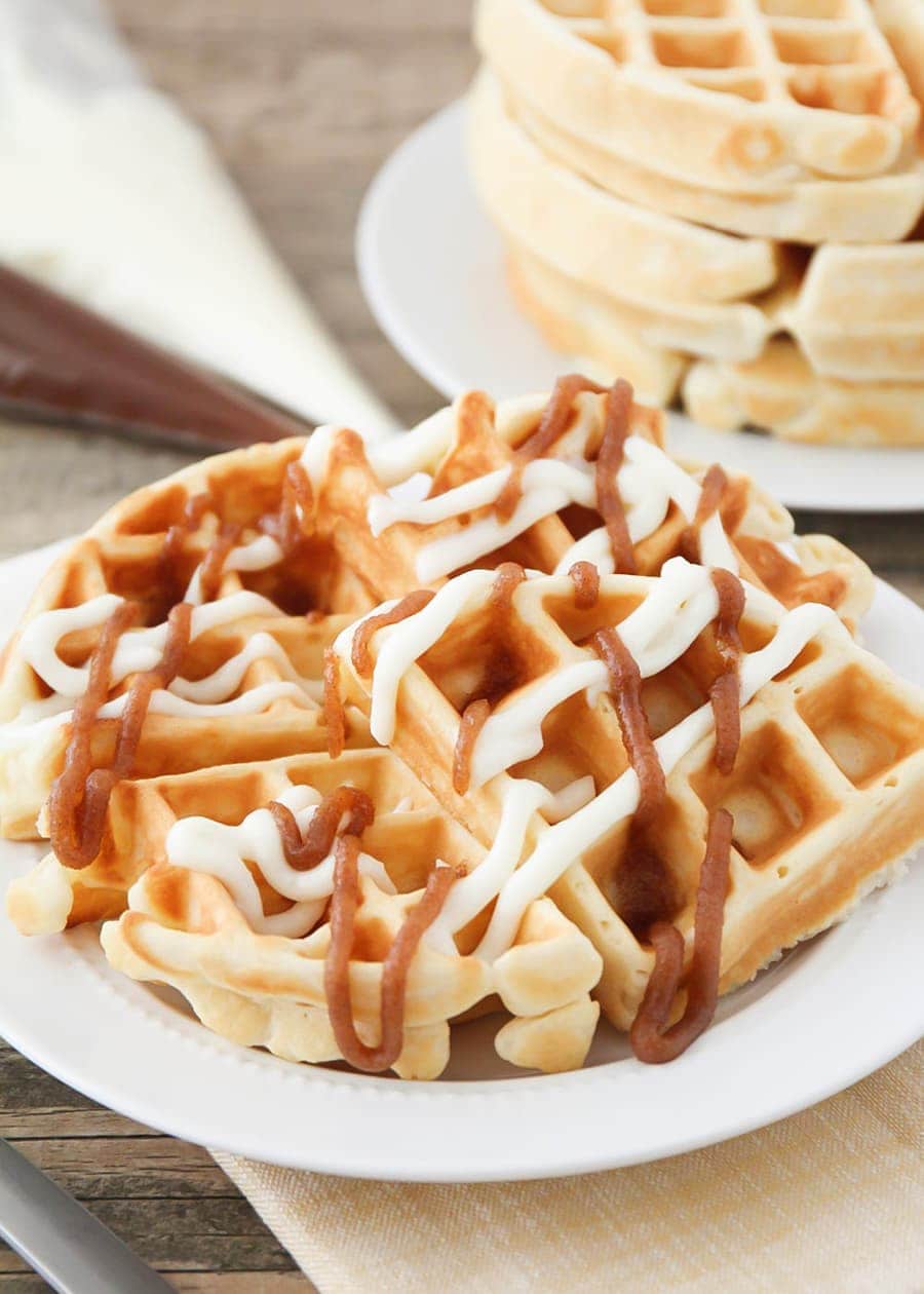Cinnamon Roll Waffles with icing on white plate