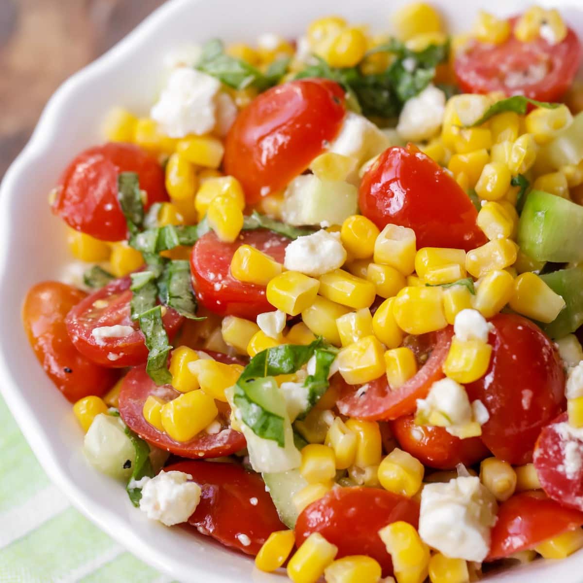 close up of corn salad in a white bowl