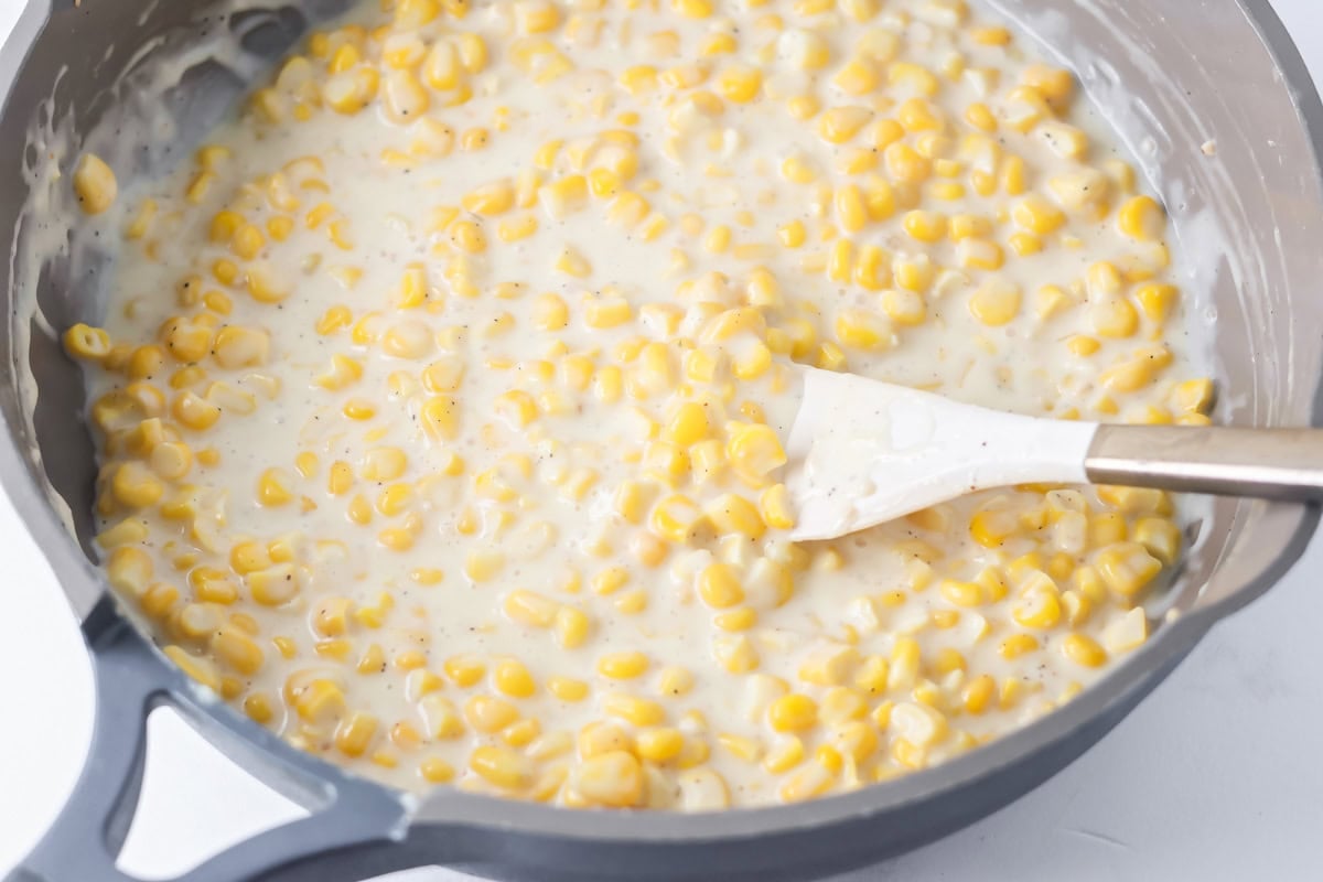 Creamed corn being made in skillet.
