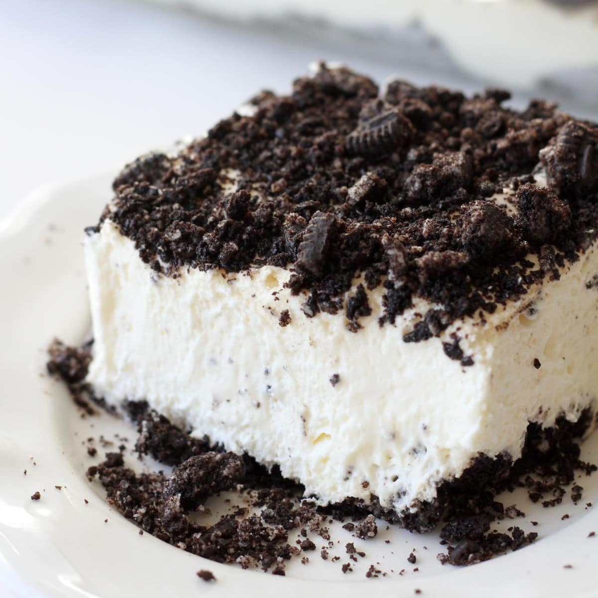 A slice of Dirt Cake served on a white plate.