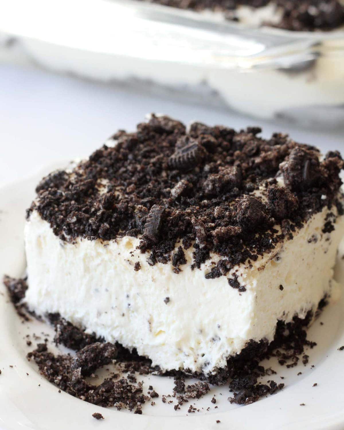 Square slice of Oreo Dirt Cake served on a white plate.