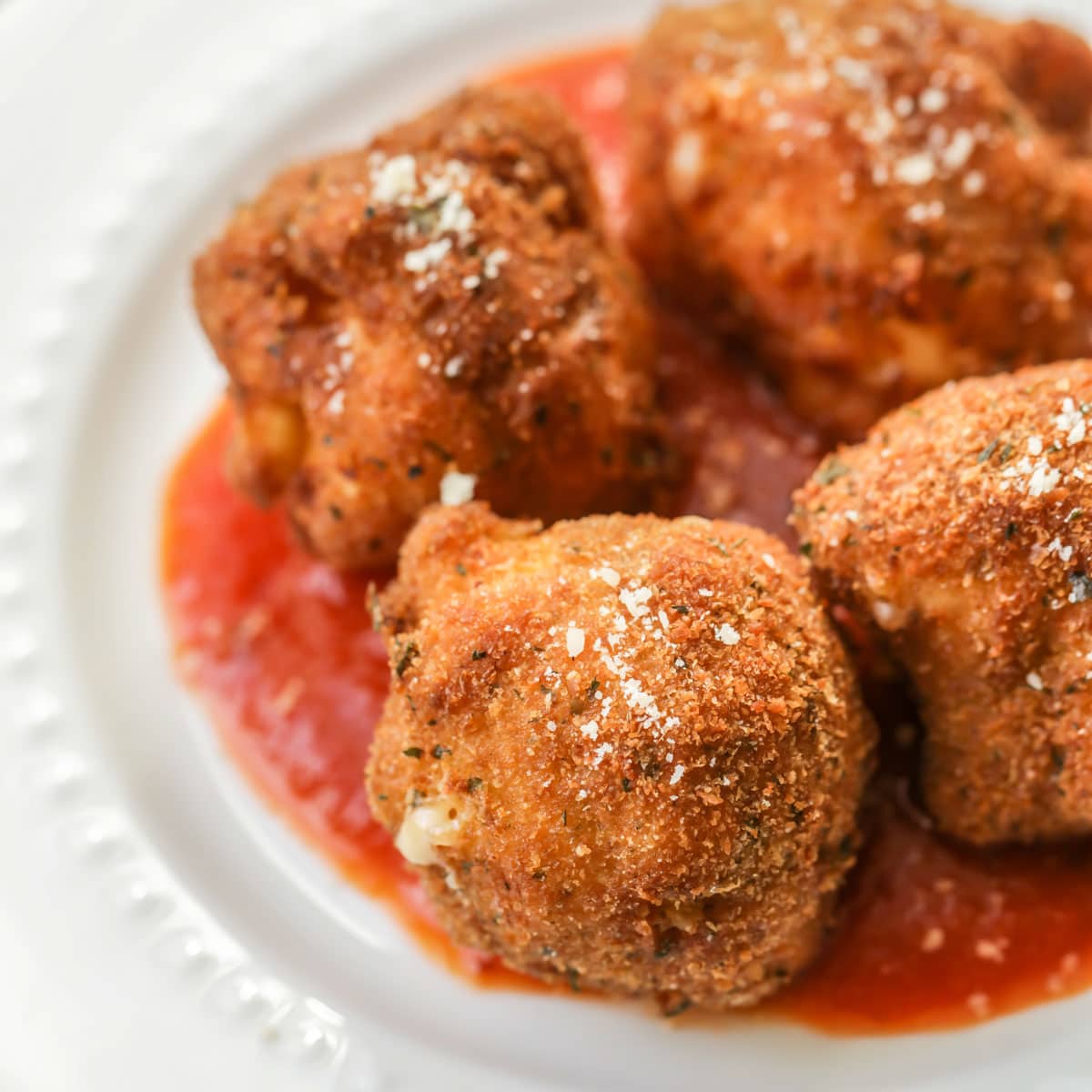 Deep fried mac and cheese balls on a white plate