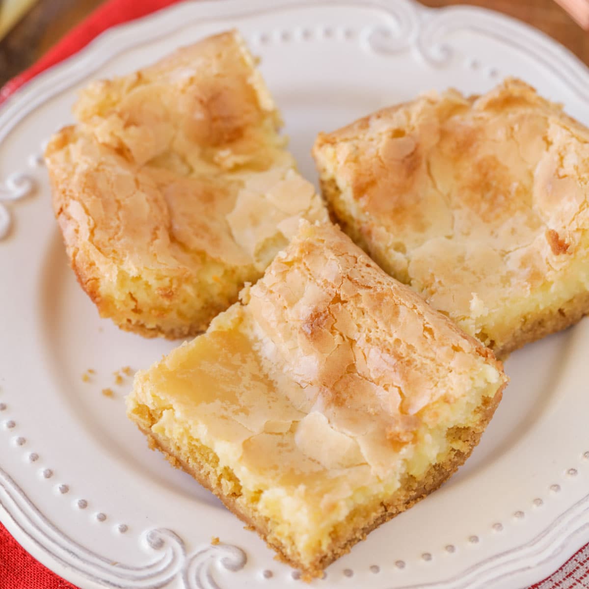 Three slices of gooey butter cake on a white plate