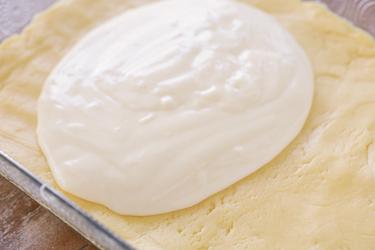 Adding gooey cream cheese layer on top of crust
