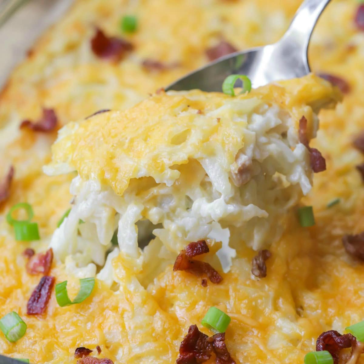 Easy side dishes - close up of cheesy hashbrown casserole topped with green onions.