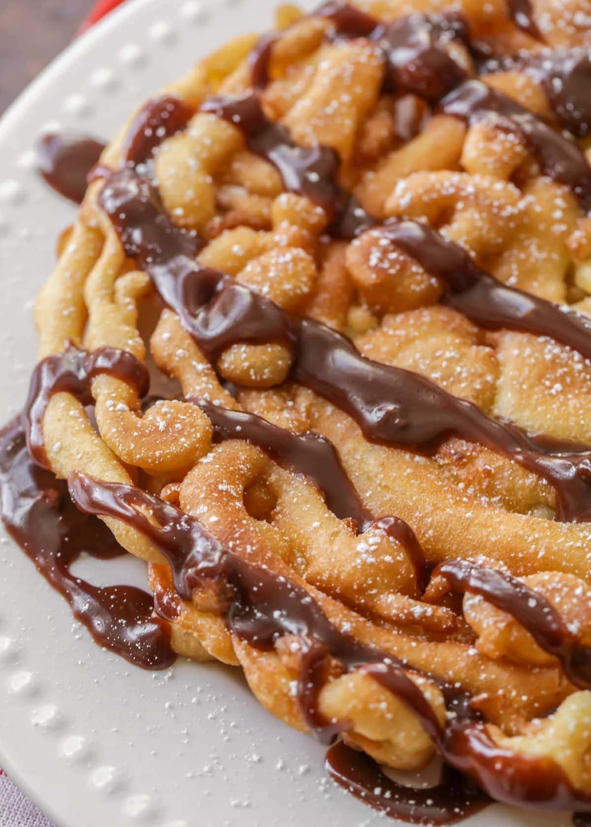 Funnel Cake Recipe with chocolate drizzled on top.