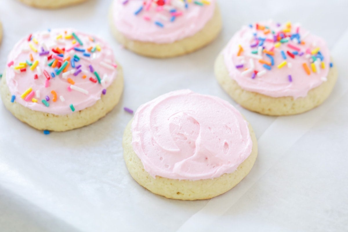 Pink frosted sugar cookies with sprinkles.