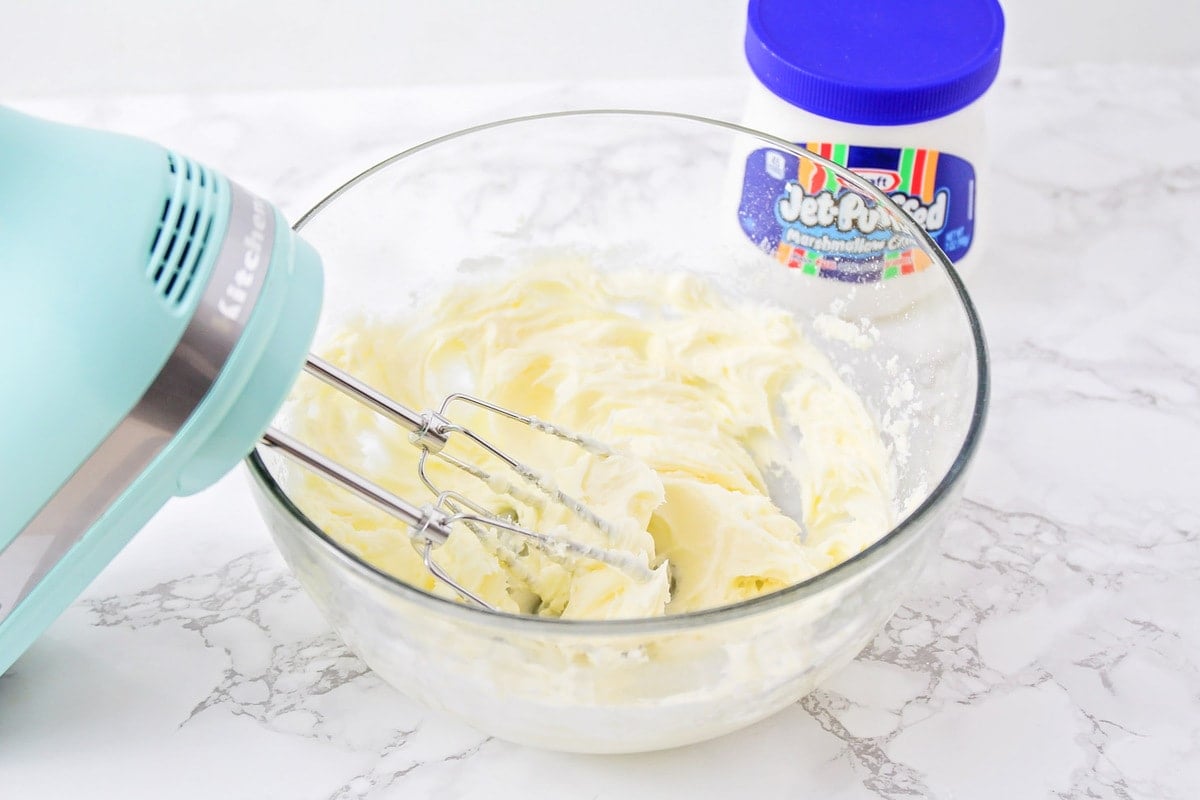 beating marshmallow fluff and butter together with a hand mixer