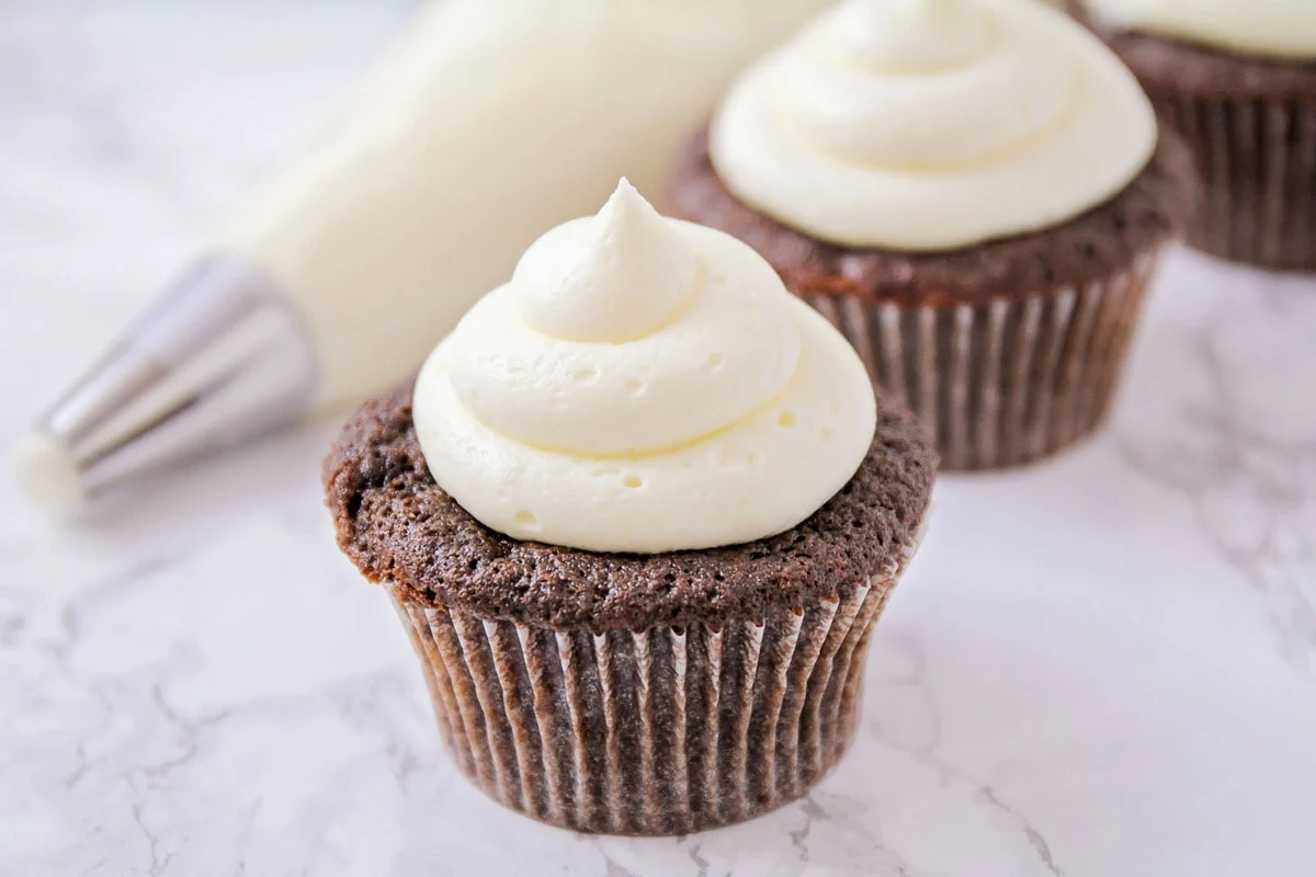 marshmallow frosting on top of a chocolate cupcake