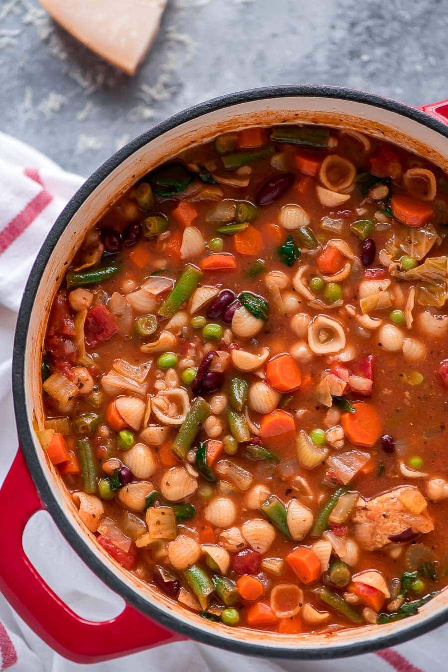 Close up of minestrone soup served in a bowl.