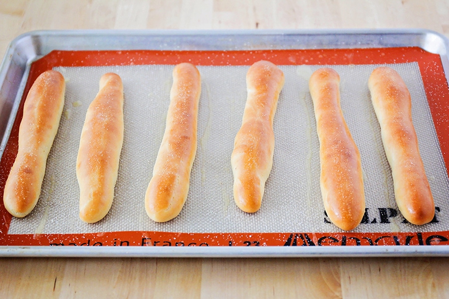 Homemade Olive Garden breadsticks baked on a sheet pan.