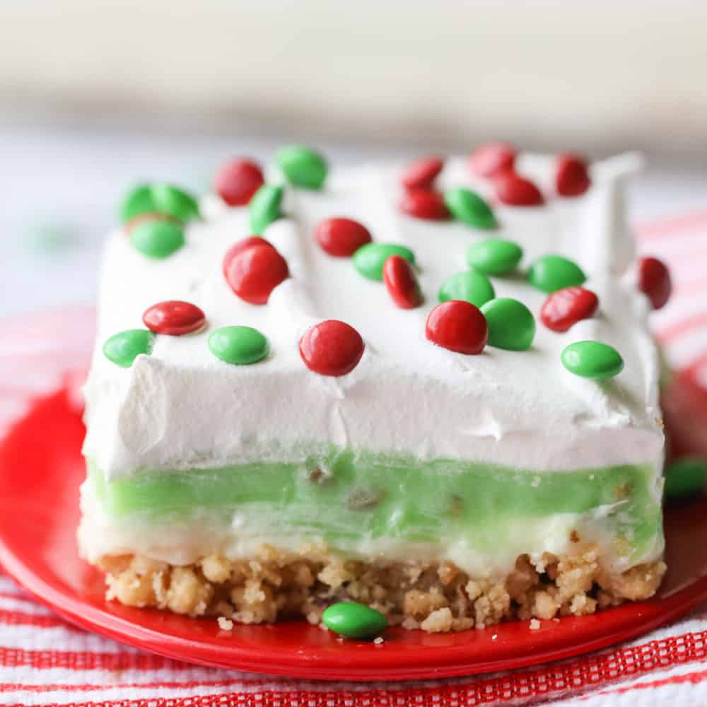 Christmas desserts - a square slice of pistachio dessert topped with red and green candies.