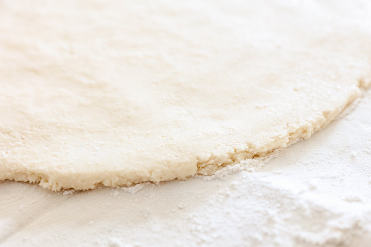 Homemade Sugar Cookie dough rolled out on pastry cloth.