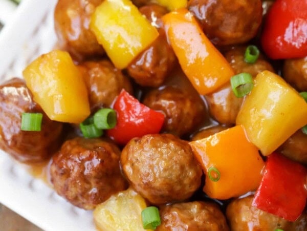 Sweet and sour meatballs recipe on white platter.