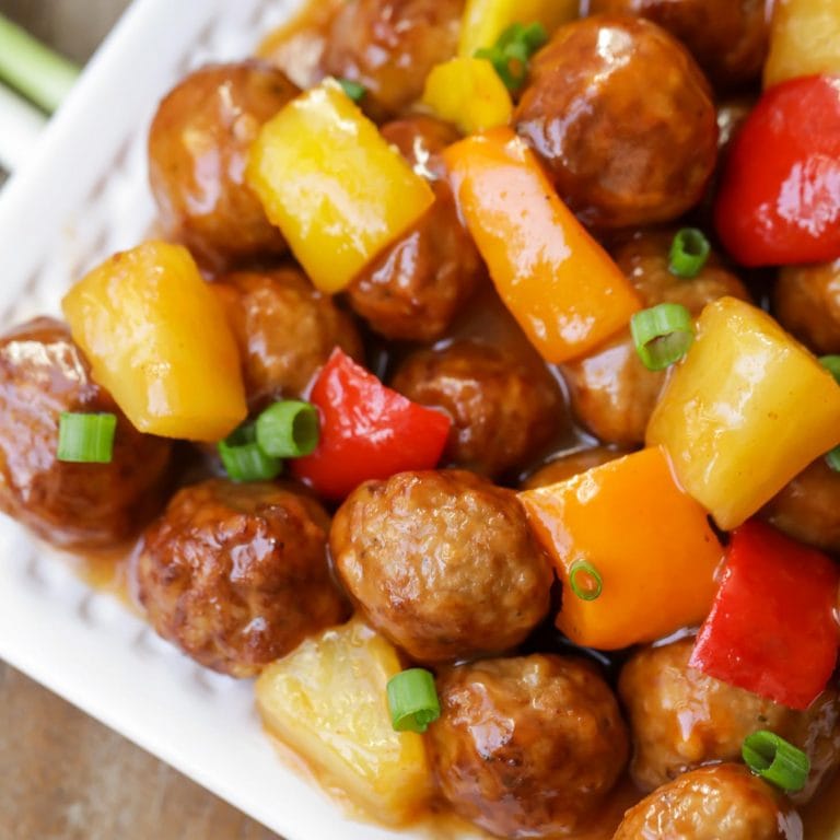Sweet and sour meatballs recipe on white platter.