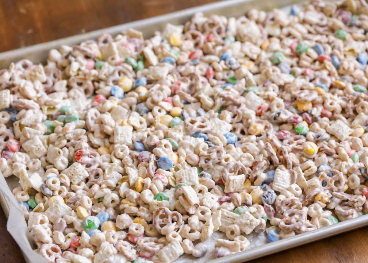 Chex mix trash spread out to cool on a sheet pan