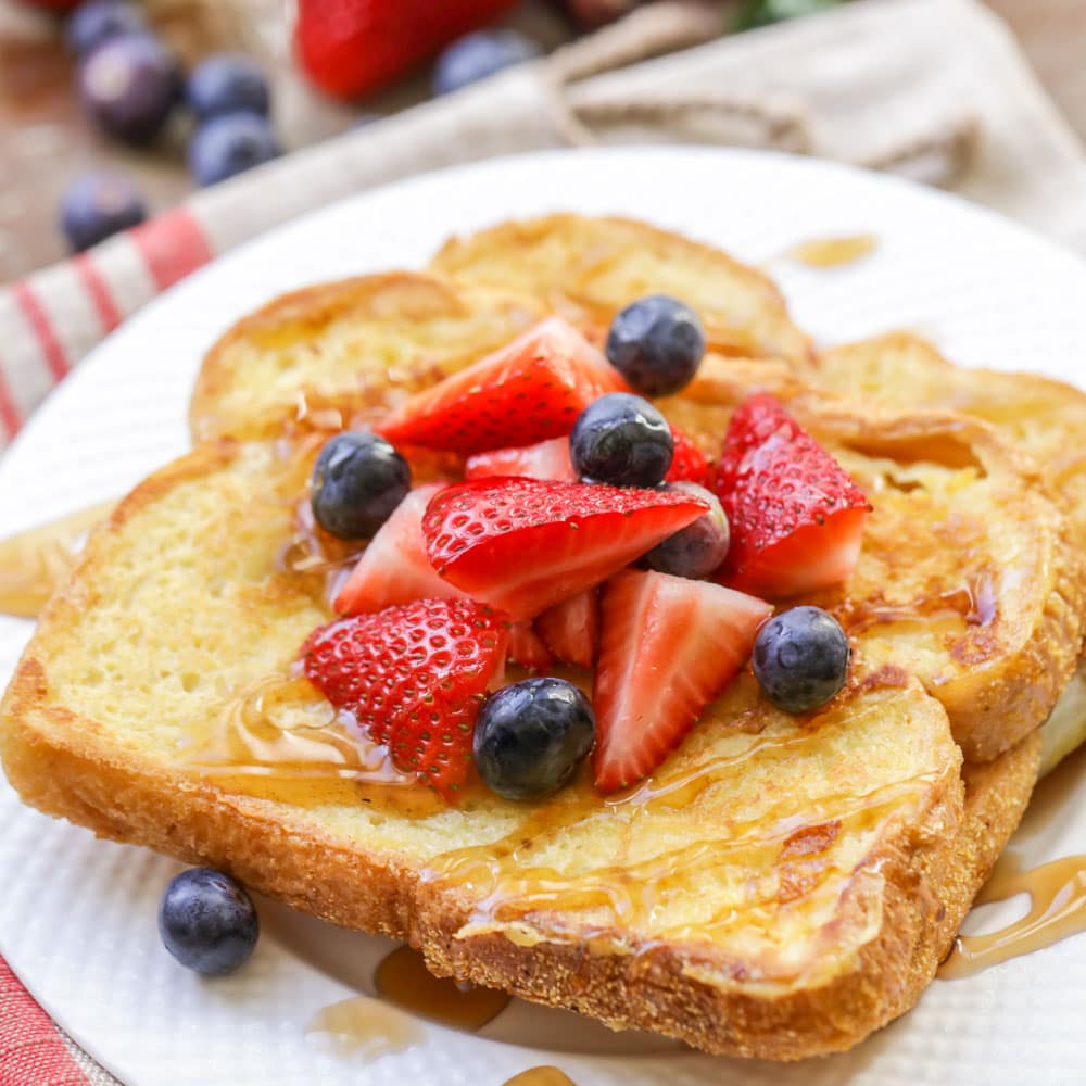 Eggnog french toast topped with berries and syrup