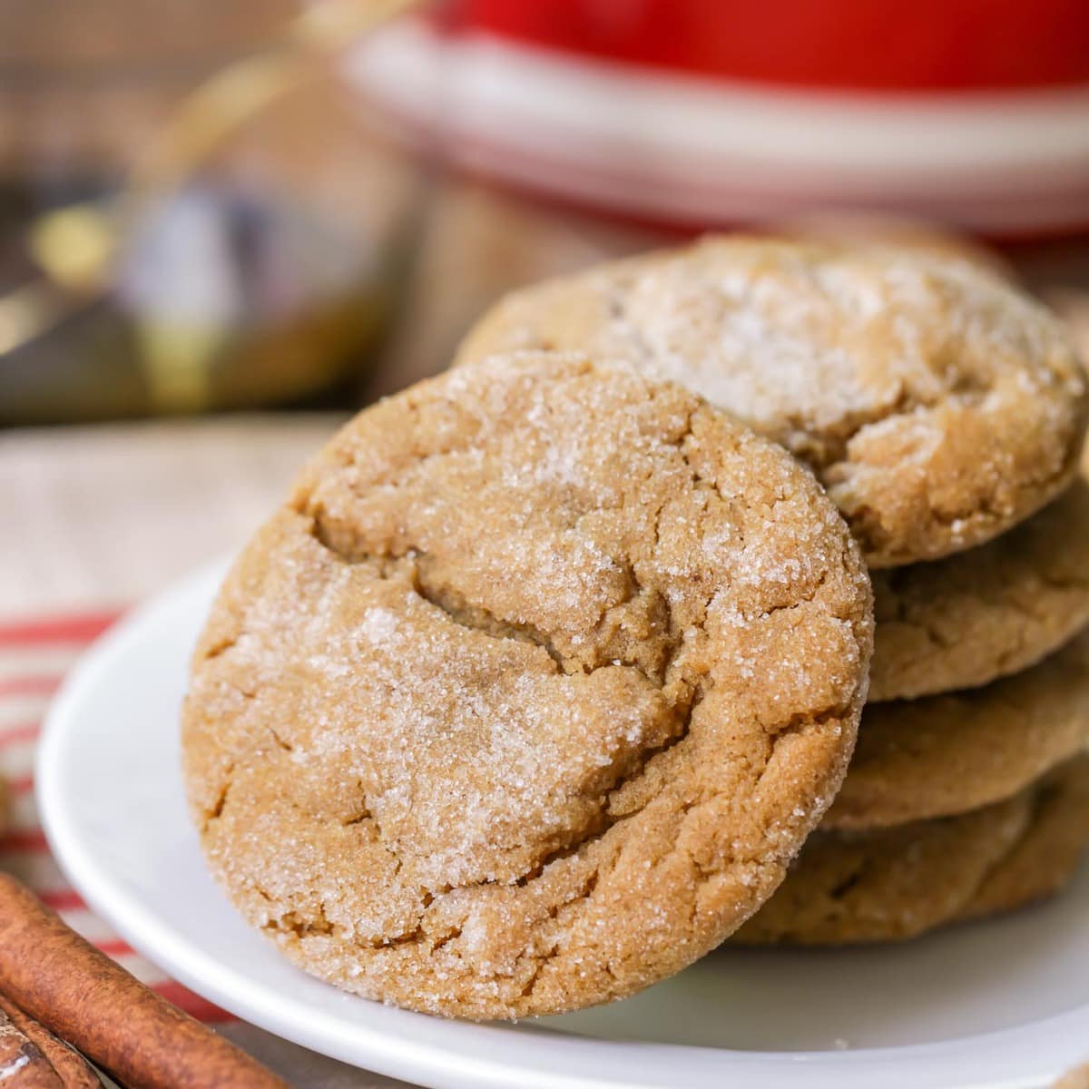 Soft ginger snap cookies stacked on plate.