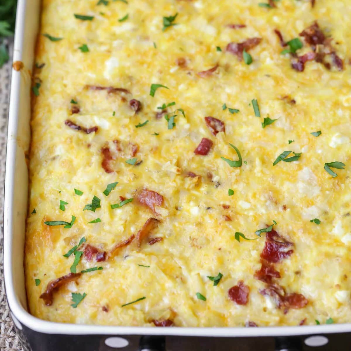 Baked hasbrown breakfast casserole topped with bacon bits.