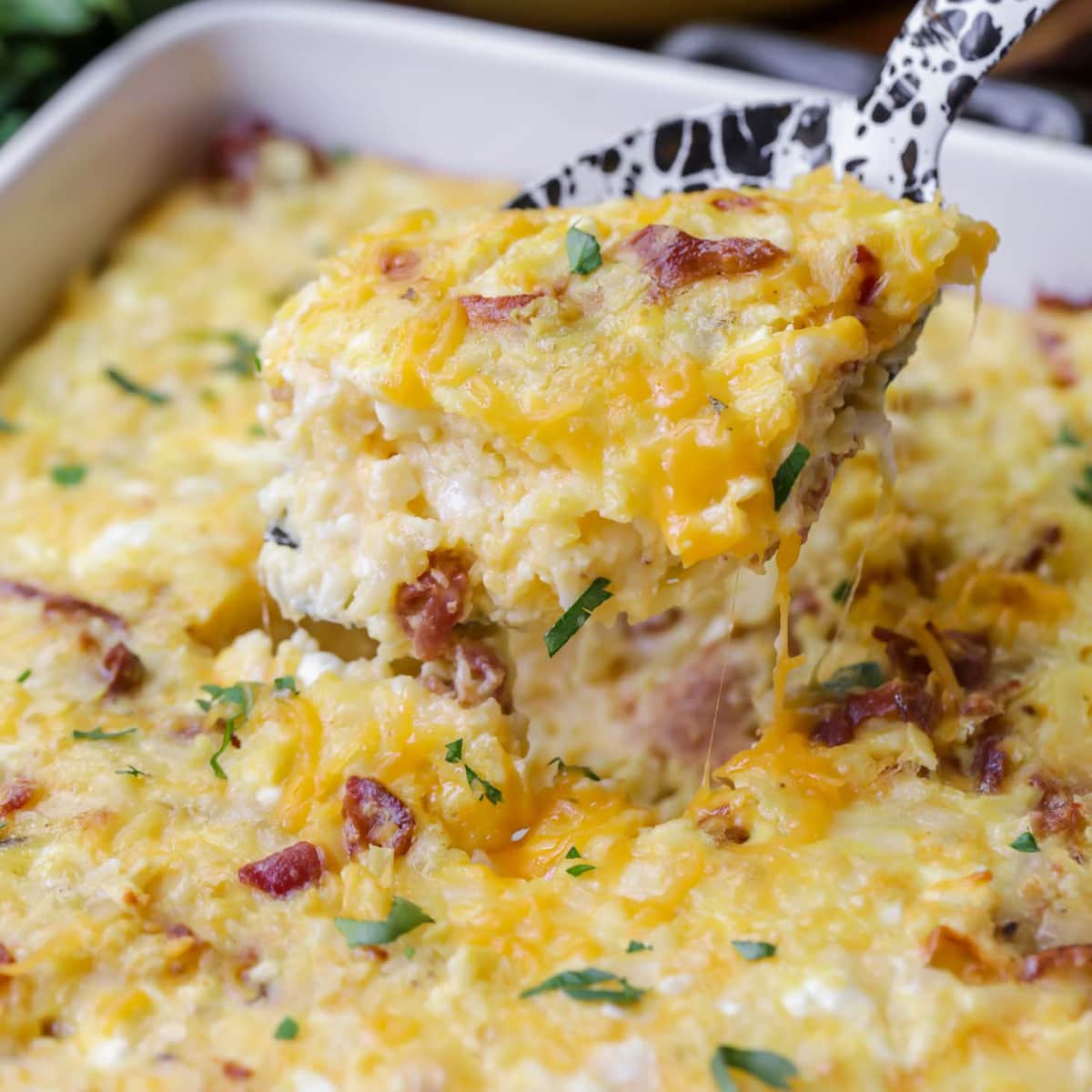 Hashbrown Breakfast Casserole scooped out from a casserole dish.