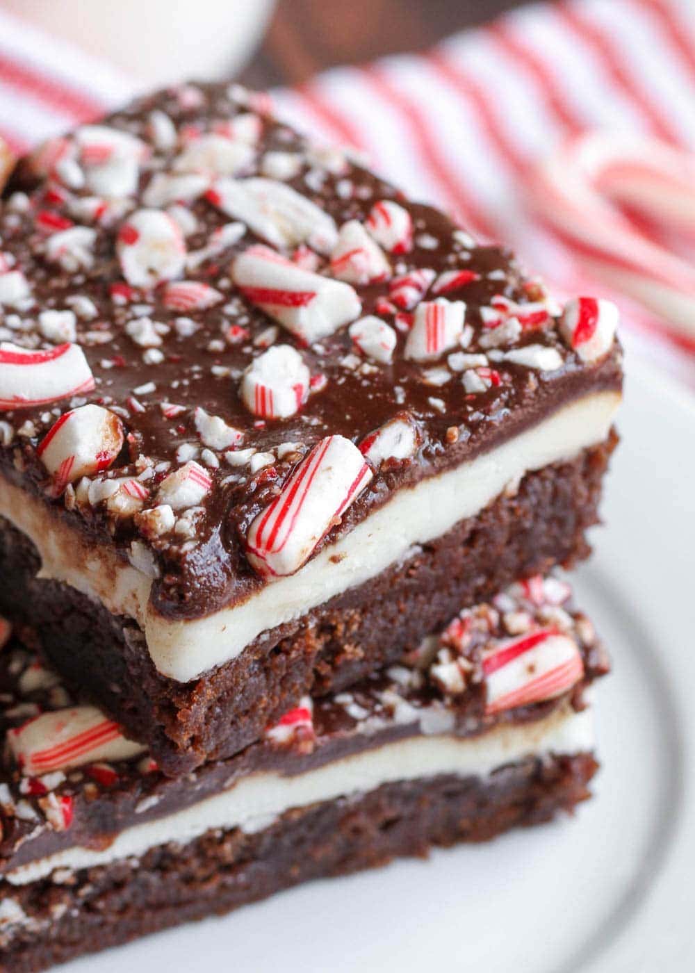 Two chocolate peppermint brownies stacked on a plate