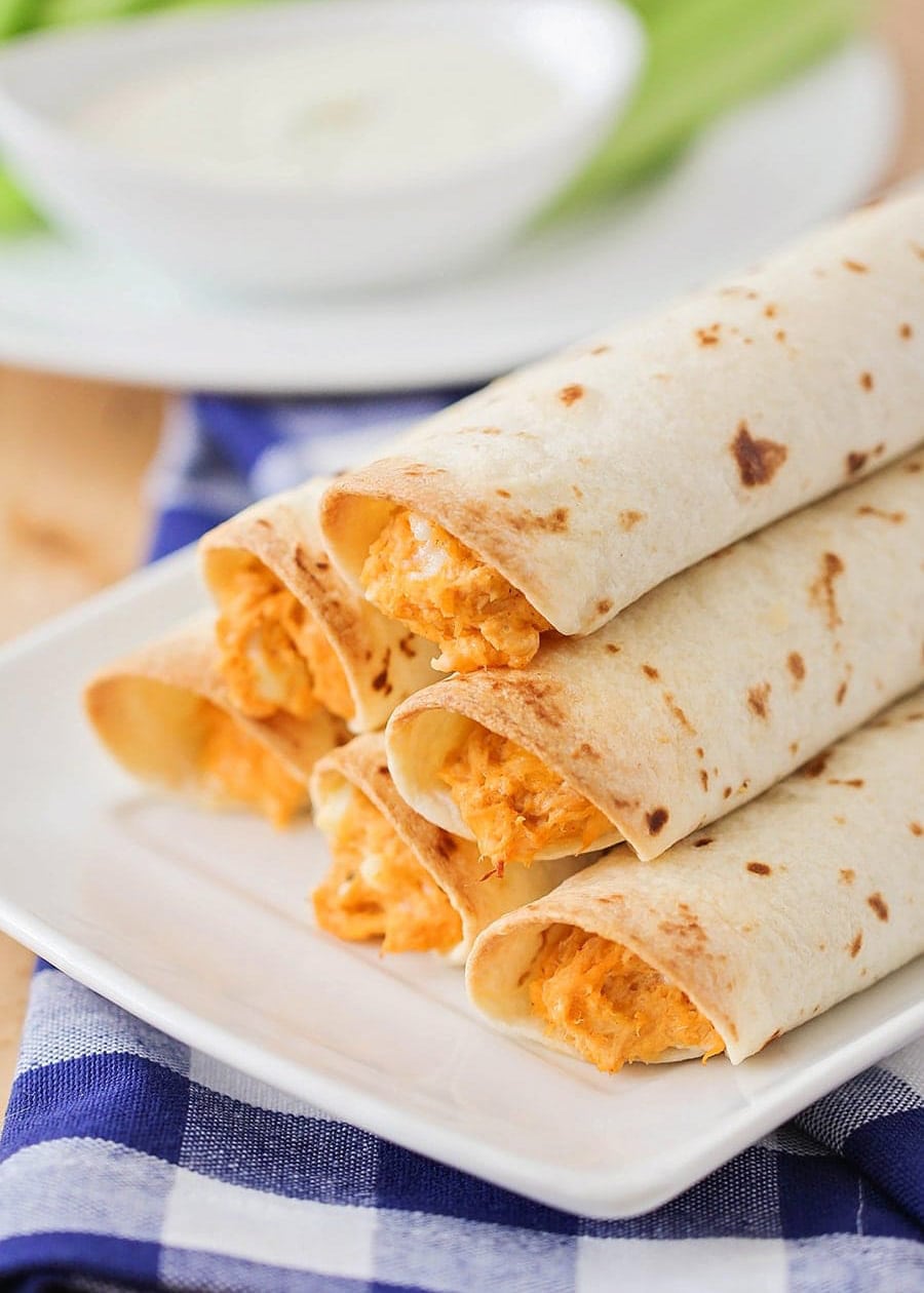 Buffalo taquitos on a white serving platter