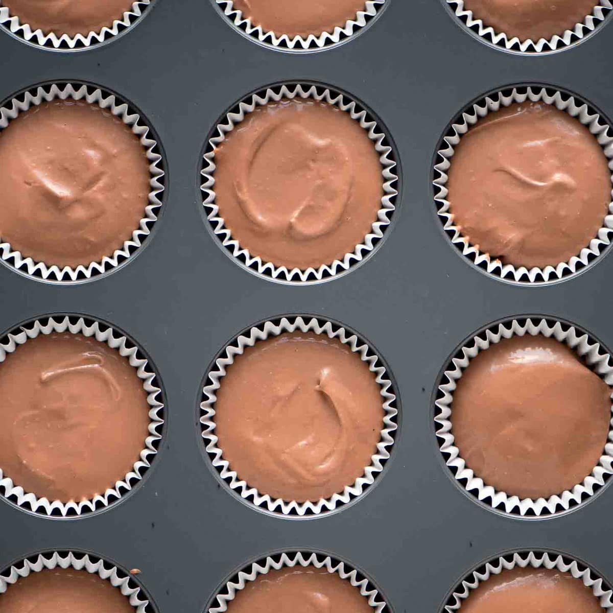 unbaked hot cocoa cheesecake mini in a muffin tin