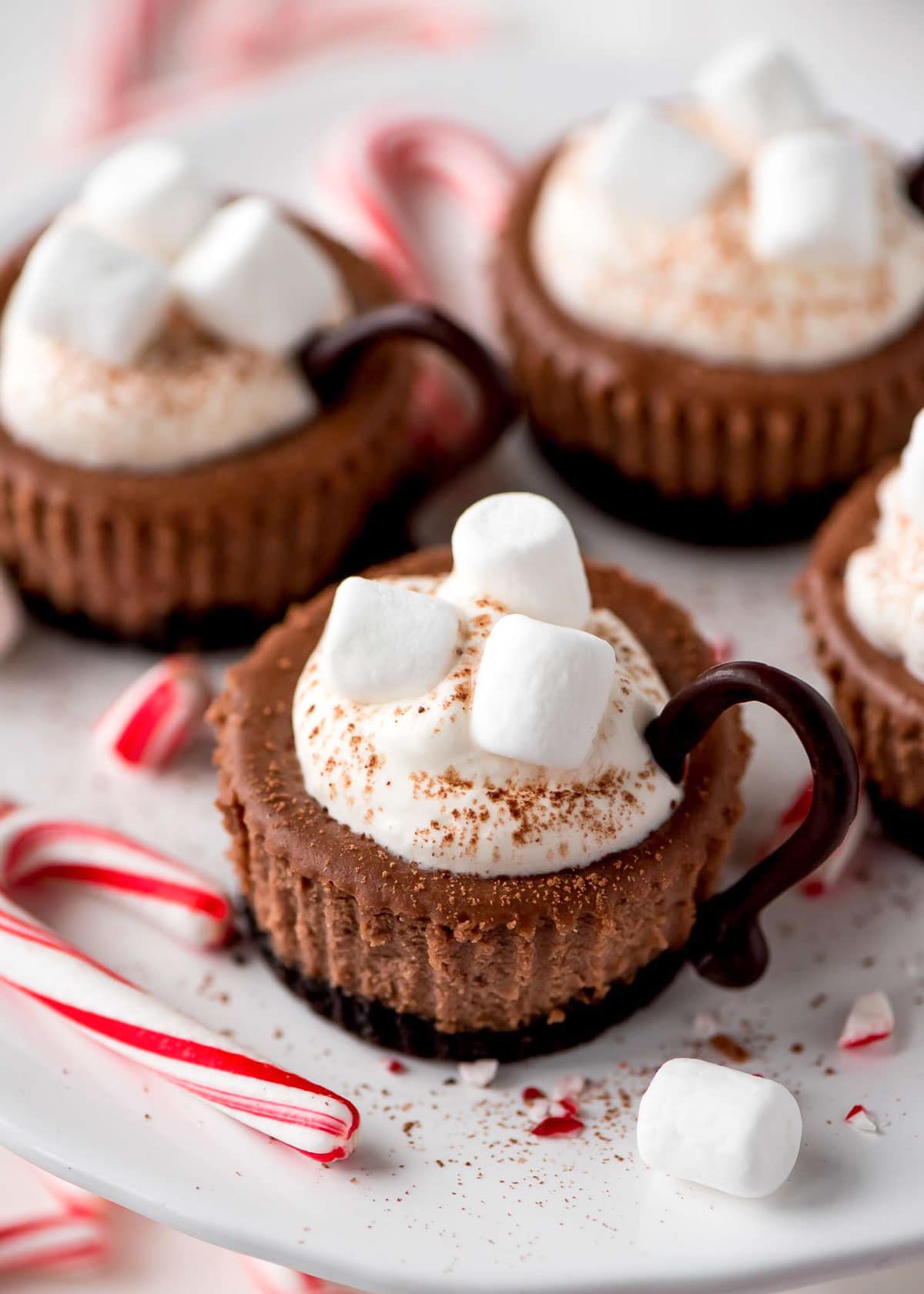 Hot cocoa cheesecake minis on a white plate
